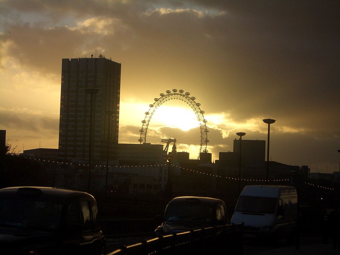 The London Eye silhouetted against a sunset